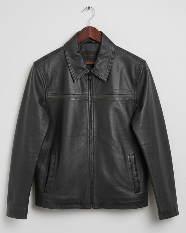 Black leather jacket on a wooden surface