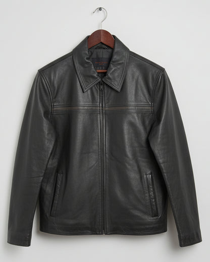 Black leather jacket on a wooden surface