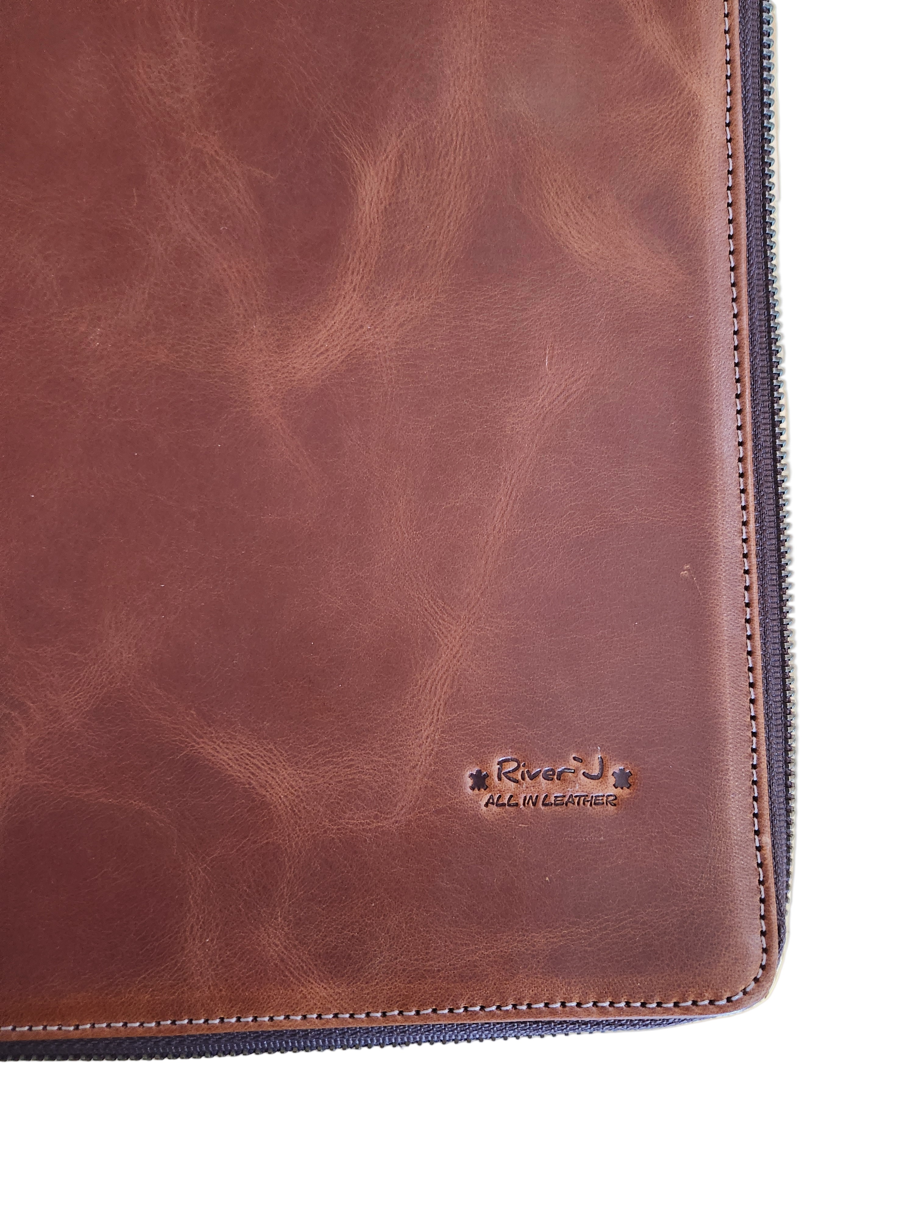 Brown leather wallet with a brand logo on a wooden surface