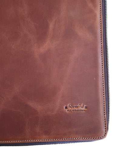 Brown leather wallet with a brand logo on a wooden surface