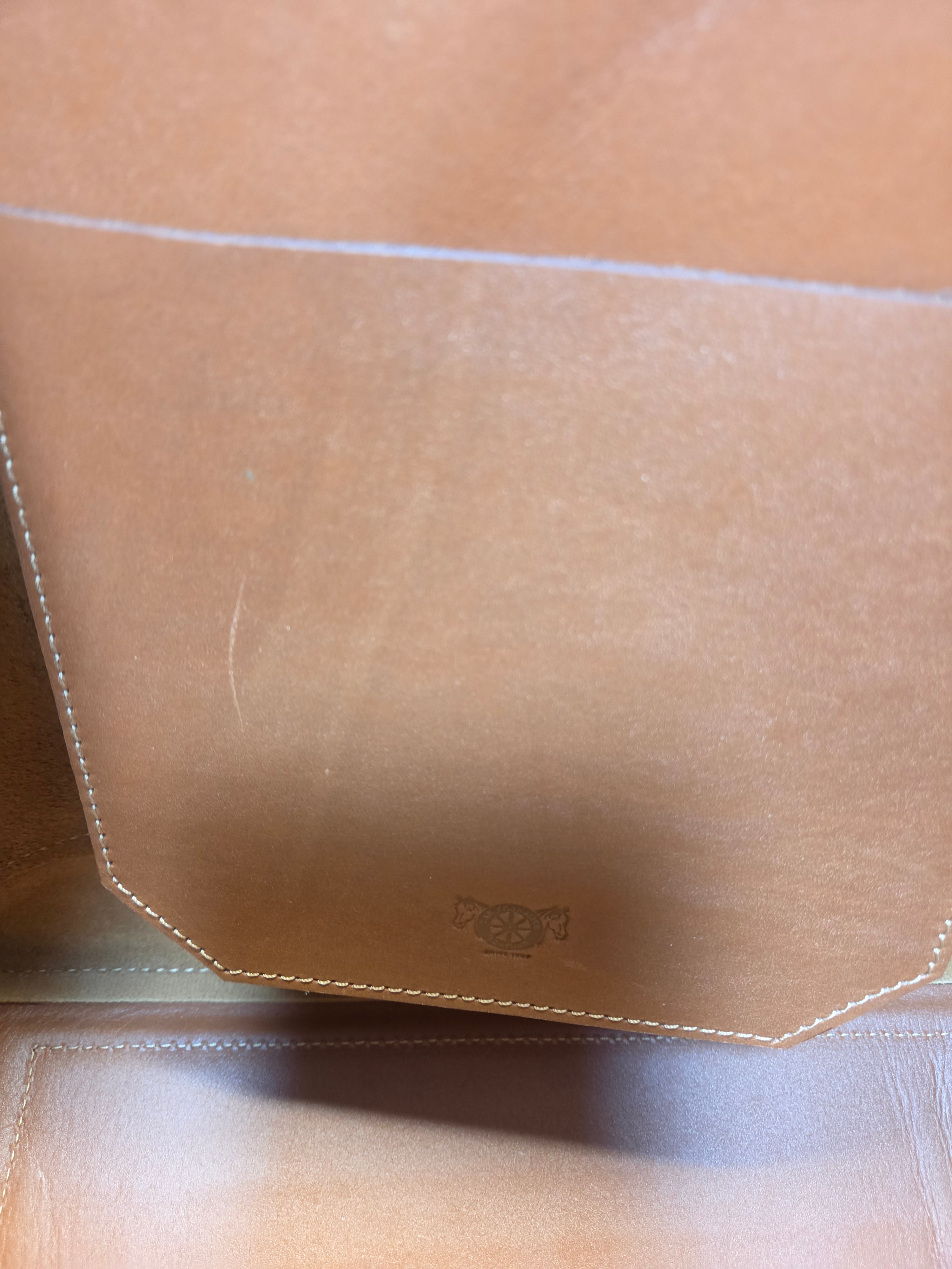 Close-up of a beige leather product with stitching details