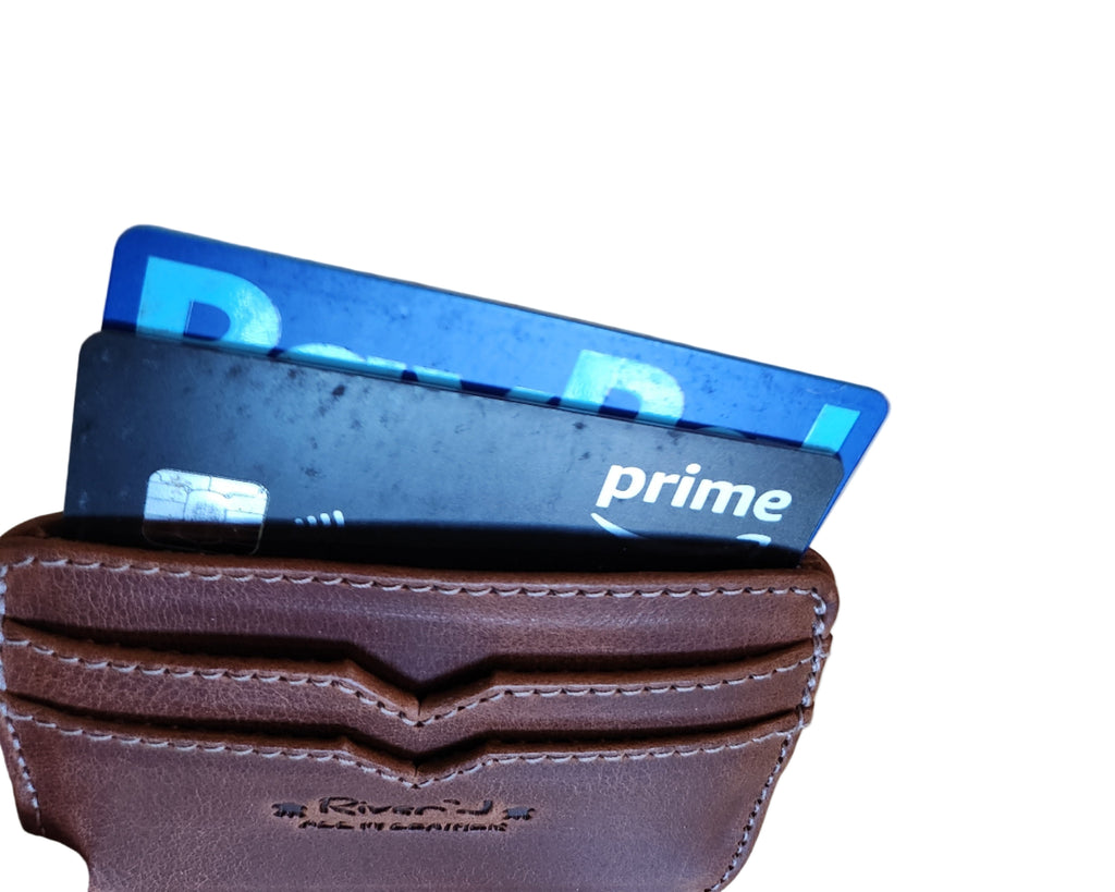 Brown wallet with two cards on a wooden surface