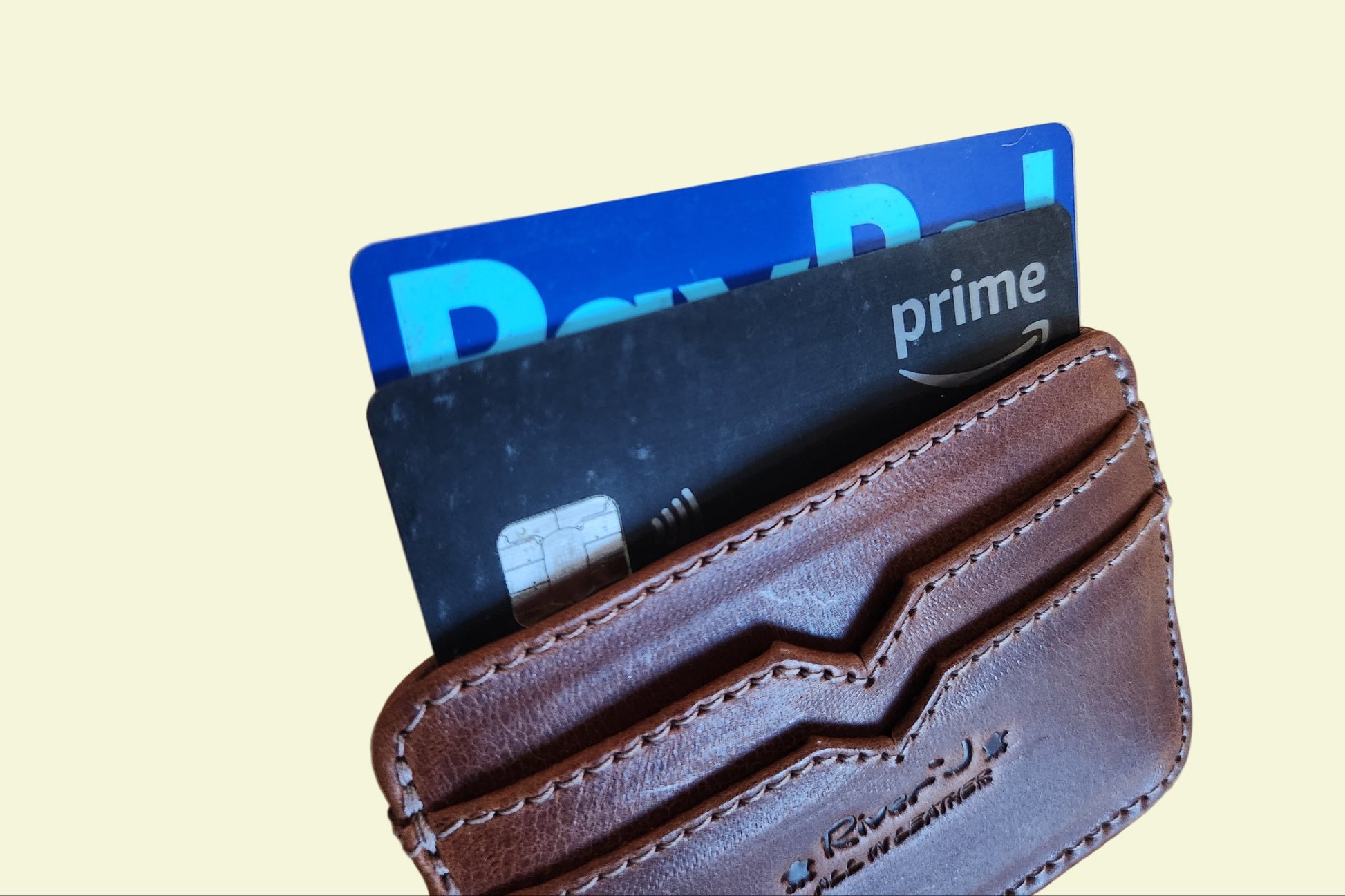 Brown leather wallet with cards on a wooden surface